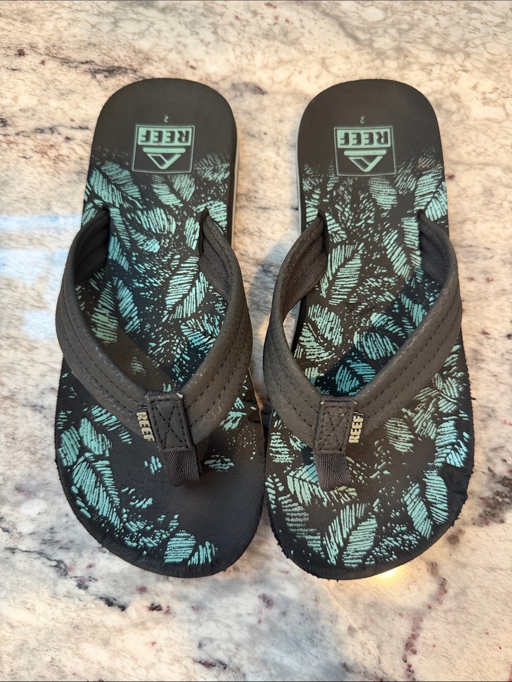 Reef Black Flip Flops with Teal Leaf Print